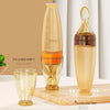 Two transparent bottles with measurement markings on a wooden surface.