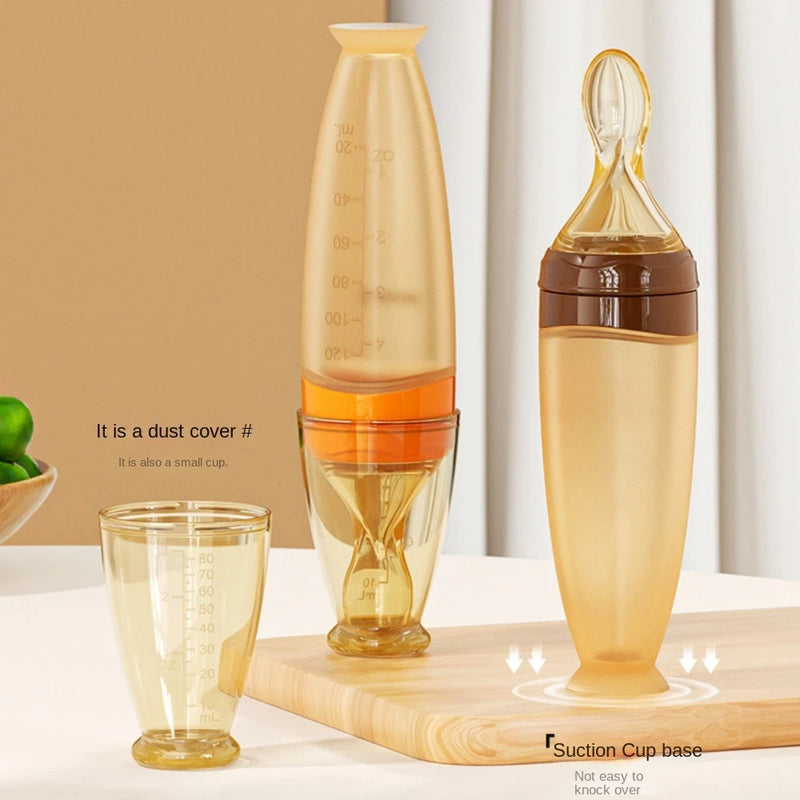 Two transparent bottles with measurement markings on a wooden surface.