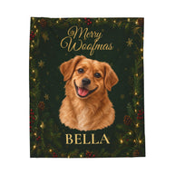 A personalized Christmas-themed blanket featuring a golden retriever portrait with the text 'Merry Woofmas' and 'BELLA' on a dark green holiday background with pine branches, pinecones, and warm lights.