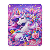 A rectangular blanket or throw featuring a colorful fantasy unicorn illustration with the name 'ZOE' printed across the lower front, shown on a plain white background.