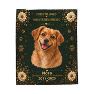 A square pet memorial blanket featuring a golden retriever portrait on a dark green background with gold floral and paw print details, plus the text 'FOREVER LOVED FOREVER REMEMBERED' and 'Nora 2011-2025'.