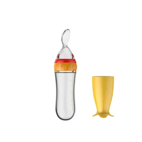 Baby feeding spoon and cup set with orange top and yellow cup on a white background