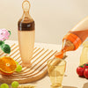 Beverage bottle being poured into a glass with fruits and flowers on a wooden surface
