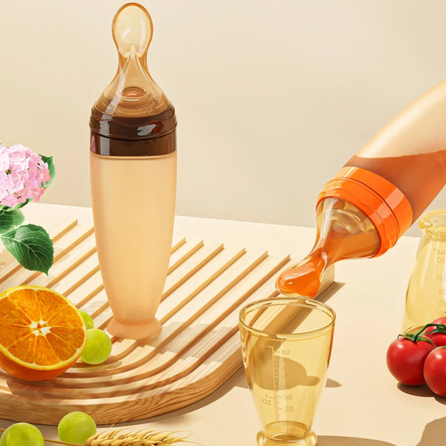 Beverage bottle being poured into a glass with fruits and flowers on a wooden surface