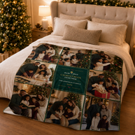 A personalized Christmas family photo quilt blanket displayed on a bed in a cozy, warmly lit bedroom with a decorated Christmas tree and lamp. The blanket features a grid of family photographs with a central dark green panel that reads 'Our First Christmas Together The Johnson Family 2026'. This is 60