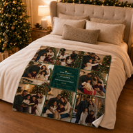 A personalized Christmas photo blanket is spread across a bed in a cozy, warmly lit bedroom. The blanket features a grid of family holiday photographs with a central dark green panel that reads 'OUR FIRST CHRISTMAS TOGETHER THE JOYFUL FAMILY 2026'. This is the 50