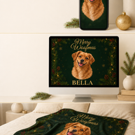 A dark green Christmas-themed blanket featuring a golden retriever portrait and the text 'Merry Christmas' and 'BELLA' is shown styled in a bedroom setting, with a matching digital mockup on a computer monitor and a phone screen above it.